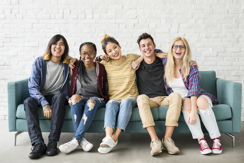 Young people on a couch smiling