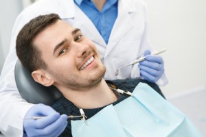 A man smiling in a dental chair
