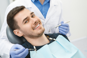 A man smiling in a dental chair