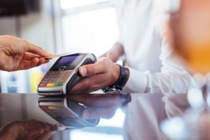 Someone using a credit card terminal